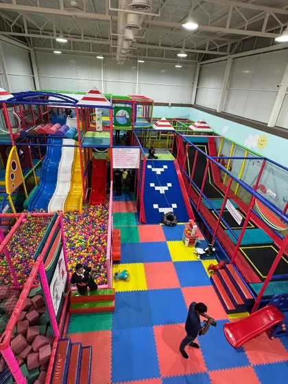 This is the heart of Kydoland, our expansive adventure zone. From this bird's-eye view, you can see the interconnected world of slides, trampolines, ball pits, and climbing structures that offer endless paths for exploration and fun.
