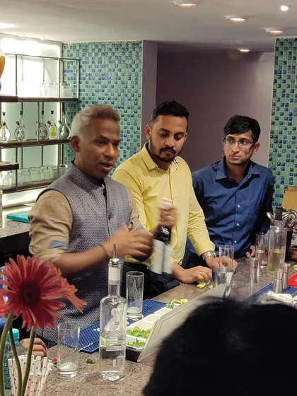 Explaining the "why" behind each step is crucial. In this session, I'm demonstrating a technique to an attentive group of aspiring mixologists.