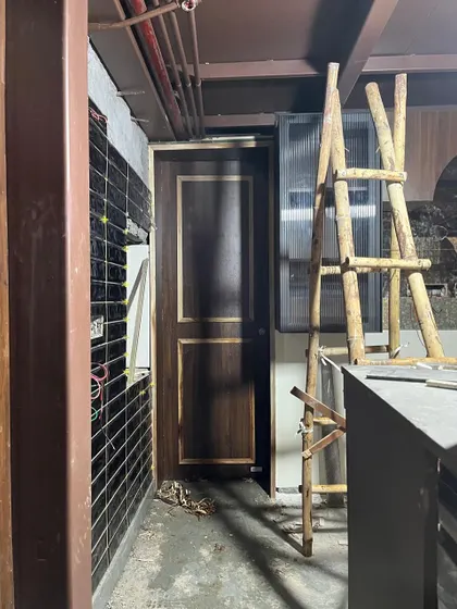 An in-progress shot from the Melt House site, showing the beginnings of wall tiling and electrical work next to a newly installed door. Every project is a complex puzzle of coordinating different trades.