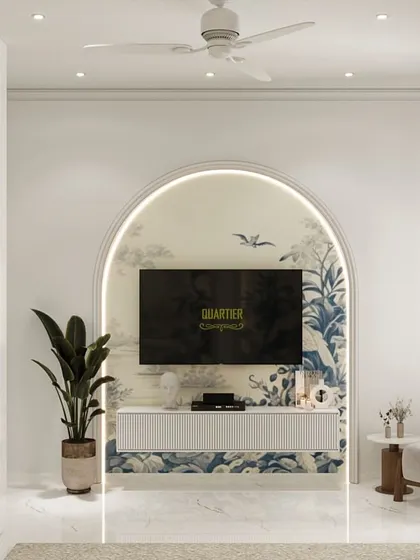 This guest bedroom design for ATS Rhapsody features an arched niche behind the TV, continuing the Chinoiserie theme from the wallpaper. The design is light, airy, and elegant, perfect for welcoming visitors.