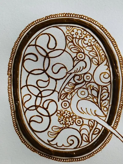 A still image of the parrot cutwork design, showing the clean lines and negative space.
