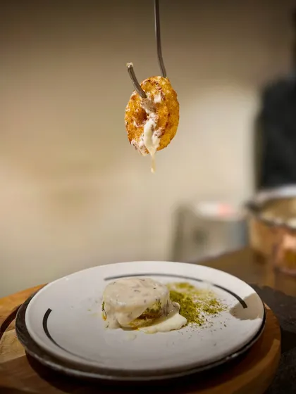 This isn't your average dessert. My Cheesy Donut is a savory delight, featuring a golden-fried ring with a molten cheese center, dramatically served to showcase its irresistible cheese drip.