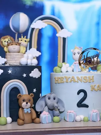 A clear, bright shot of the twin animal-themed cakes, perfect for a joint birthday party.