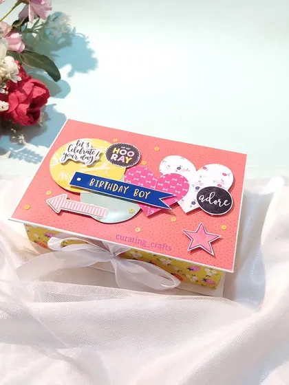 The cover of the birthday mini scrapbook, tied with a ribbon.