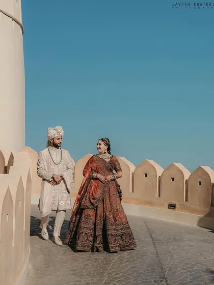 A majestic long shot showing how the complete look, including the hairstyle, comes together for a royal wedding photo.
