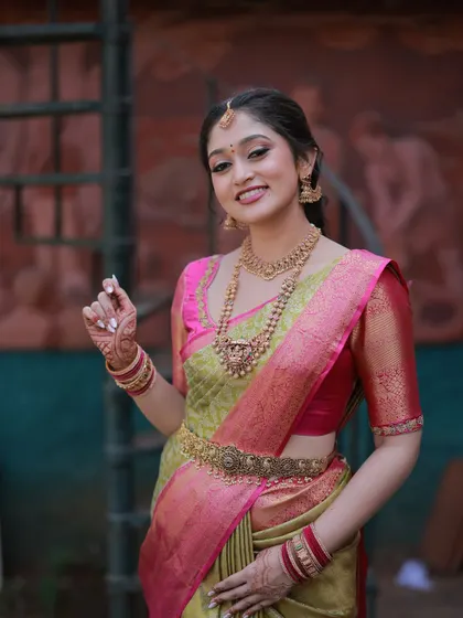 The bride's smile says it all. Her makeup is fresh and glowing, and her hair is styled to perfection, creating a complete and cohesive bridal look.