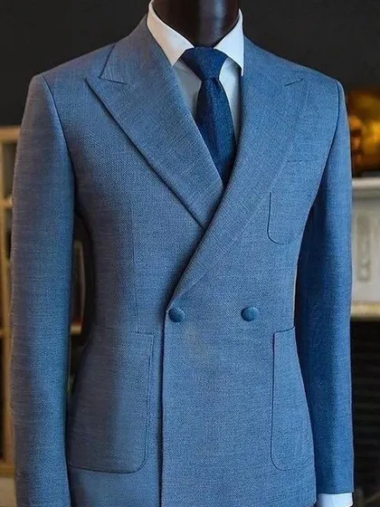A light blue double-breasted suit with patch pockets. A relaxed yet very stylish take on formal tailoring.