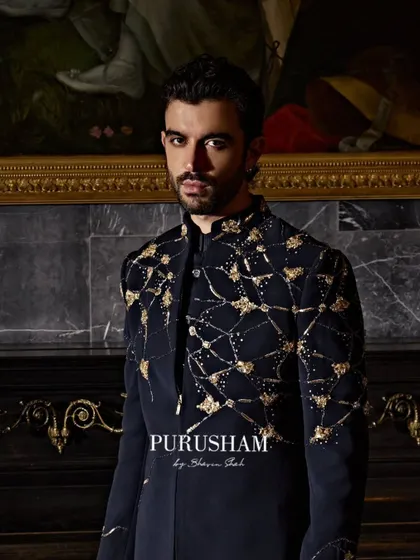 Purusham men level up. This jacket, with its sharp cuts and golden geometry, is an entrance waiting to happen.
