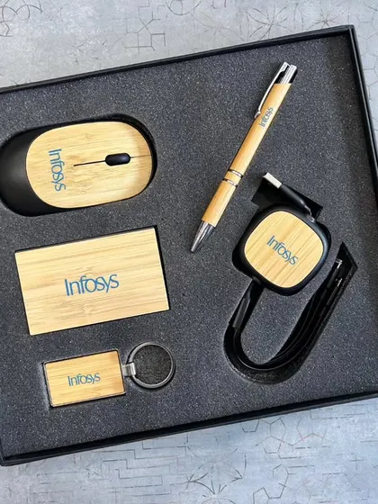For a more sustainable option, I offer eco-friendly tech kits. This set for Infosys features a wireless mouse, retractable USB cable, card holder, pen, and keychain, all made with bamboo and customized with their logo.
