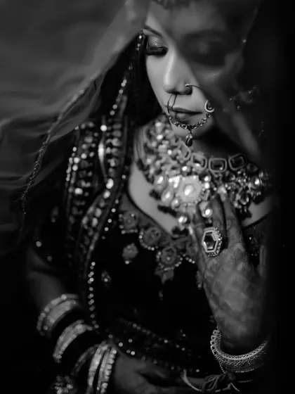 A beautiful black and white portrait of the bride under her veil. This timeless style emphasizes emotion and the intricate details of her attire.