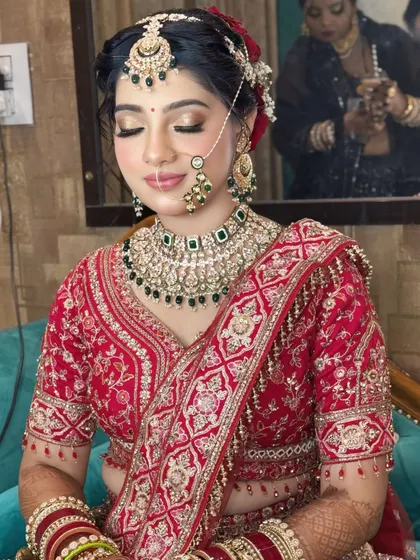 A soft, romantic take on the red bridal look. The focus here is on glowing skin and shimmery golden eyes, with a softer lip color for a modern touch.