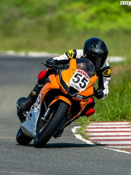 Rider Parichay Sharma demonstrates perfect cornering form, leaning deep into the turn. This image captures the dynamic balance between rider and machine that we teach at the academy.