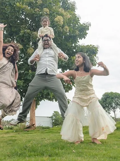 This is what pure, chaotic joy looks like. We believe family photos should be about capturing your unique energy, and outdoor sessions in a place like this Bangalore field give us the space to let everyone's true personality shine.