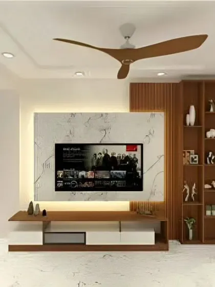 A closer look at the TV unit from our contemporary living room project. The design highlights the beautiful contrast between the white marble panel, the warm wood console, and the vertical display shelving.