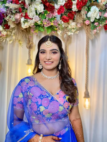A happy and radiant client, ready for her daytime ceremony. The makeup is colorful yet soft, perfect for celebrating in the sun.