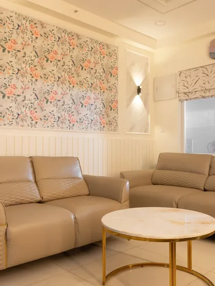 A cozy seating arrangement in the living room, featuring plush leatherette sofas and a modern coffee table, perfect for family gatherings.