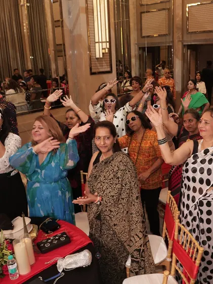 Guests dancing and enjoying the party, with polka dots and retro fashion on full display.