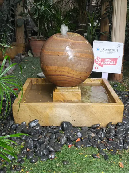 Another view of the sphere fountain, highlighting the wet stone which brings out the deep, rich colors of the Rainbow Sandstone.