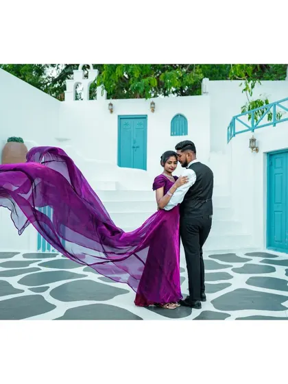 A duplicate of ID 179, this photo captures the beautiful movement of the bride's purple dress against the clean lines of the Santorini-style architecture.