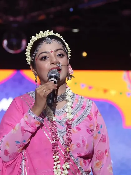 Another angle of me hosting as Radha. The professional stage lighting and setup at 'Rangilo Re' highlight my ability to perform in high-production environments.