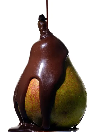 An experiment with a pear and melted chocolate. The way the thick chocolate drapes over the fruit creates a decadent and sculptural form, turning a simple food pairing into a piece of art.