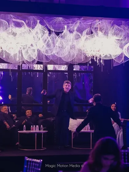 Guests enjoy a performance in the lounge area, which features a ceiling of metal mesh and crystals.