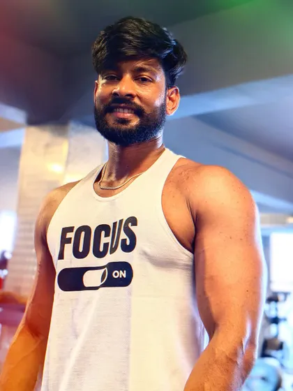 "Sweat is just a warm-up." A post-workout shot showing the arm pump and vascularity.