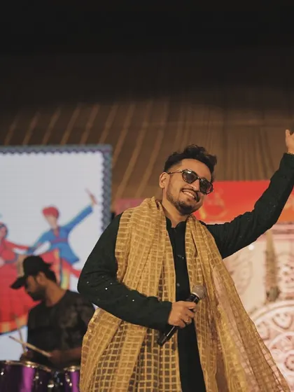 A candid shot from a magical Garba night in Surat. Waving to the crowd, I felt completely connected to the incredible energy of the dancers. These are the moments I live for as a performer.