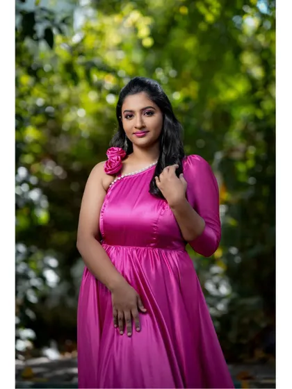 A lovely portrait showcasing the flattering neckline and elegant sleeve of the pink satin gown. The color is vibrant and photographs beautifully in natural light.