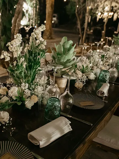The details of a forest dinner tablescape. We used a mix of white florals, succulents, and patterned plates to create a look that was both rustic and refined, perfectly complementing the natural surroundings.