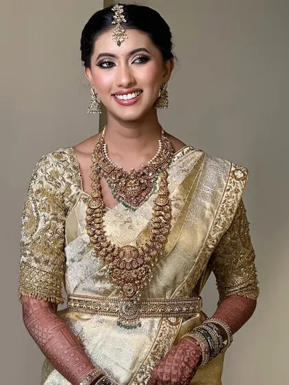 A full view of this stunning bridal ensemble. The intricate gold embroidery on the blouse perfectly complements the rich texture of the Kanchivaram saree.