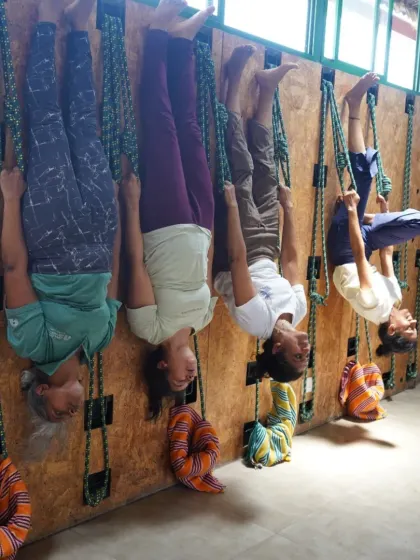 A line of students enjoying the feeling of lightness and freedom in a hanging inversion during our rope yoga workshop. This practice is both challenging and deeply restorative.