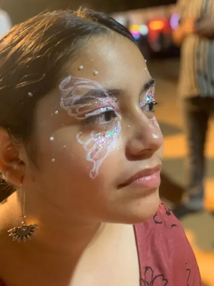 An angelic look created with white paint and iridescent glitter, giving a frosty, ethereal vibe.