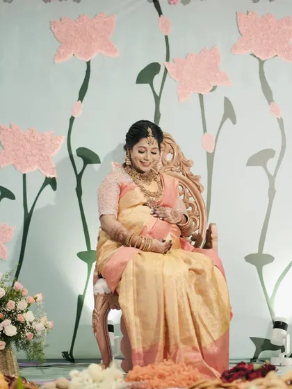 A serene portrait of the mother-to-be at her lotus-themed baby shower.