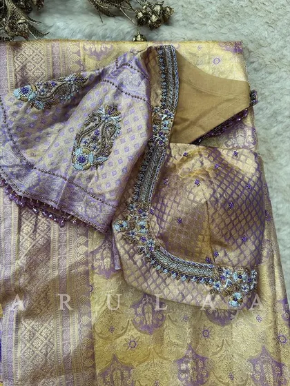 The front view of the lavender brocade blouse, showing how the embroidery is placed on the sleeves and neckline to complement the rich fabric.