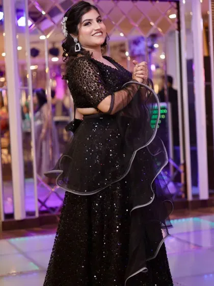 The full look, showing how the ruffled dupatta and sequin lehenga create a dramatic and stylish party outfit.