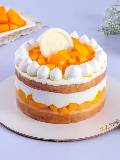 Another look at my popular Mango Vanilla cake. You can see the distinct layers of sponge, cream, and heaps of fresh mango, making it a light yet satisfying dessert.