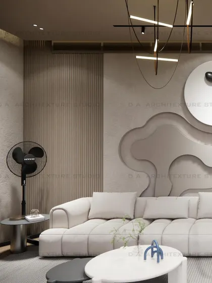 A close-up of the living area in the day room, showing the textured wall with 3D art, a comfortable white sofa, and modern lighting.