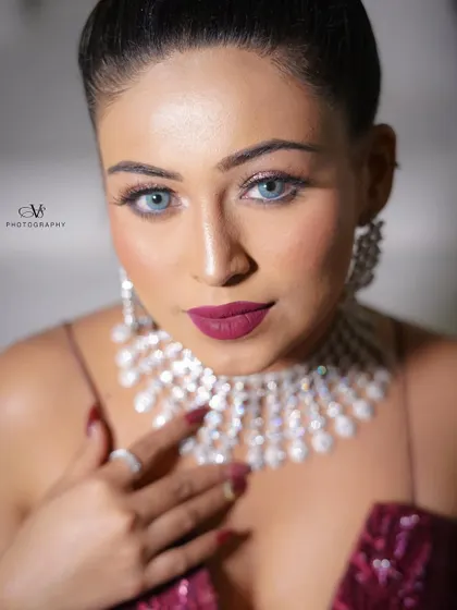 A striking close-up portrait of the bride on her engagement day, highlighting her flawless makeup and dazzling diamond jewelry.