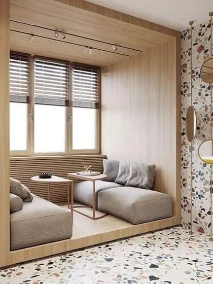 A cozy, sunken seating area built into a wooden alcove. This is a unique design concept for creating an intimate conversation spot in a living room.