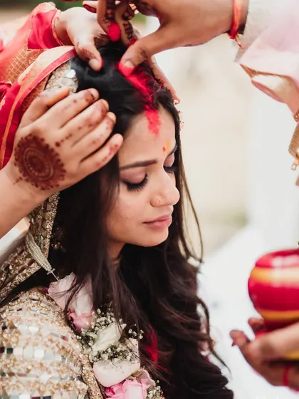 The 'sindoor' ceremony, a pivotal moment where the groom applies vermilion to his bride, symbolizing their new status as a married couple. These are the traditions I help you honor.