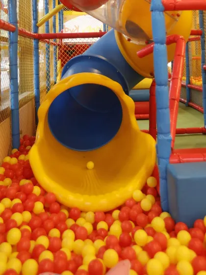 A close-up of our yellow tunnel slide, a key feature of our indoor play area. It provides a safe and exciting ride for children of all ages.