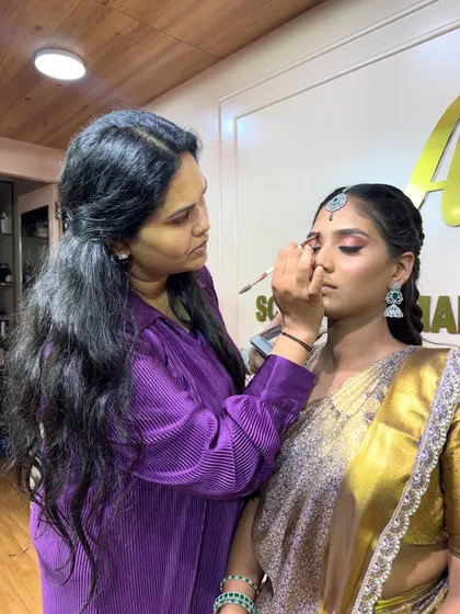 A live demonstration of a Muhurtham look in progress. Students get an up-close view of every step before they practice themselves.
