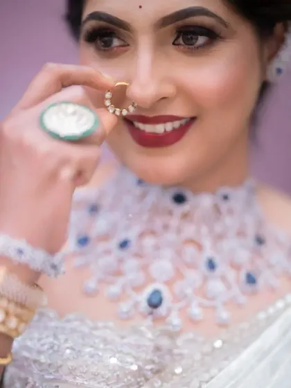 A close-up shot of this wedding guest, focusing on her happy smile, bold red lip, and the stunning diamond nose ring.
