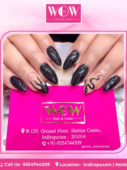 Edgy and chic, this design features a combination of glossy black nails and accent nails with snake and flame patterns on a neutral base. Perfect for a bold, statement-making look.