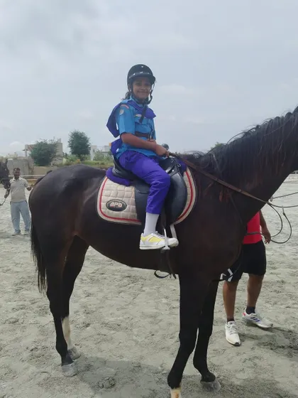This student demonstrates good posture and confidence while riding, showcasing the skills she has developed in our horse riding classes.