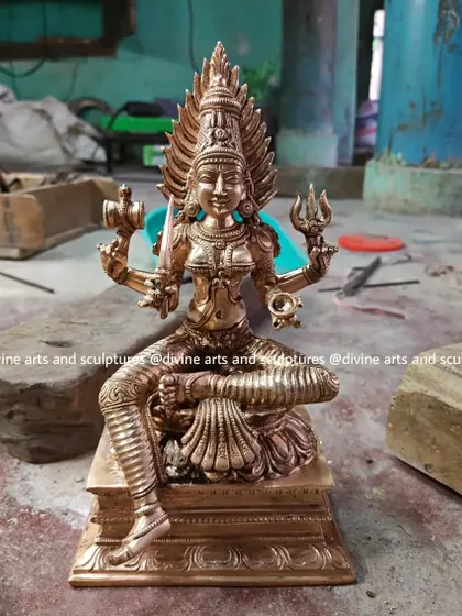 An 8-inch Panchaloha sculpture of Mariamman, freshly finished and resting on a stone block in our workshop. This image captures the satisfying moment a piece is completed and ready for its journey.