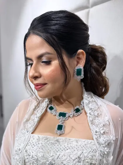 A messy ponytail adorned with small diamond pins for a touch of sparkle.