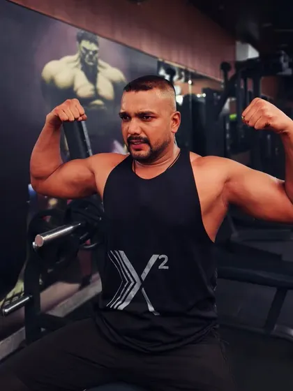 Flexing the results of hard work. I believe in building real, natural muscle through consistent weight training.