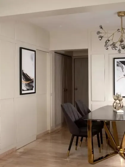 A shot of the dining area, showing how the hidden bar is concealed within the wall paneling. This seamless integration keeps the focus on the dining table and the art, maintaining a clean and uncluttered look.